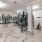 brightly lit bicycle storage and repair room with standing racks