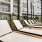 lounge chairs and side tables poolside