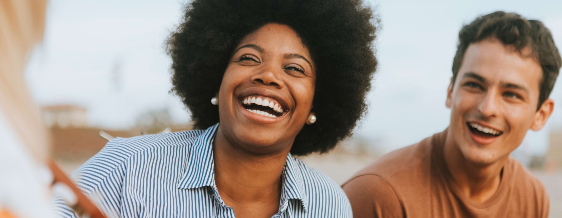Two people laughing and eating watermelon
